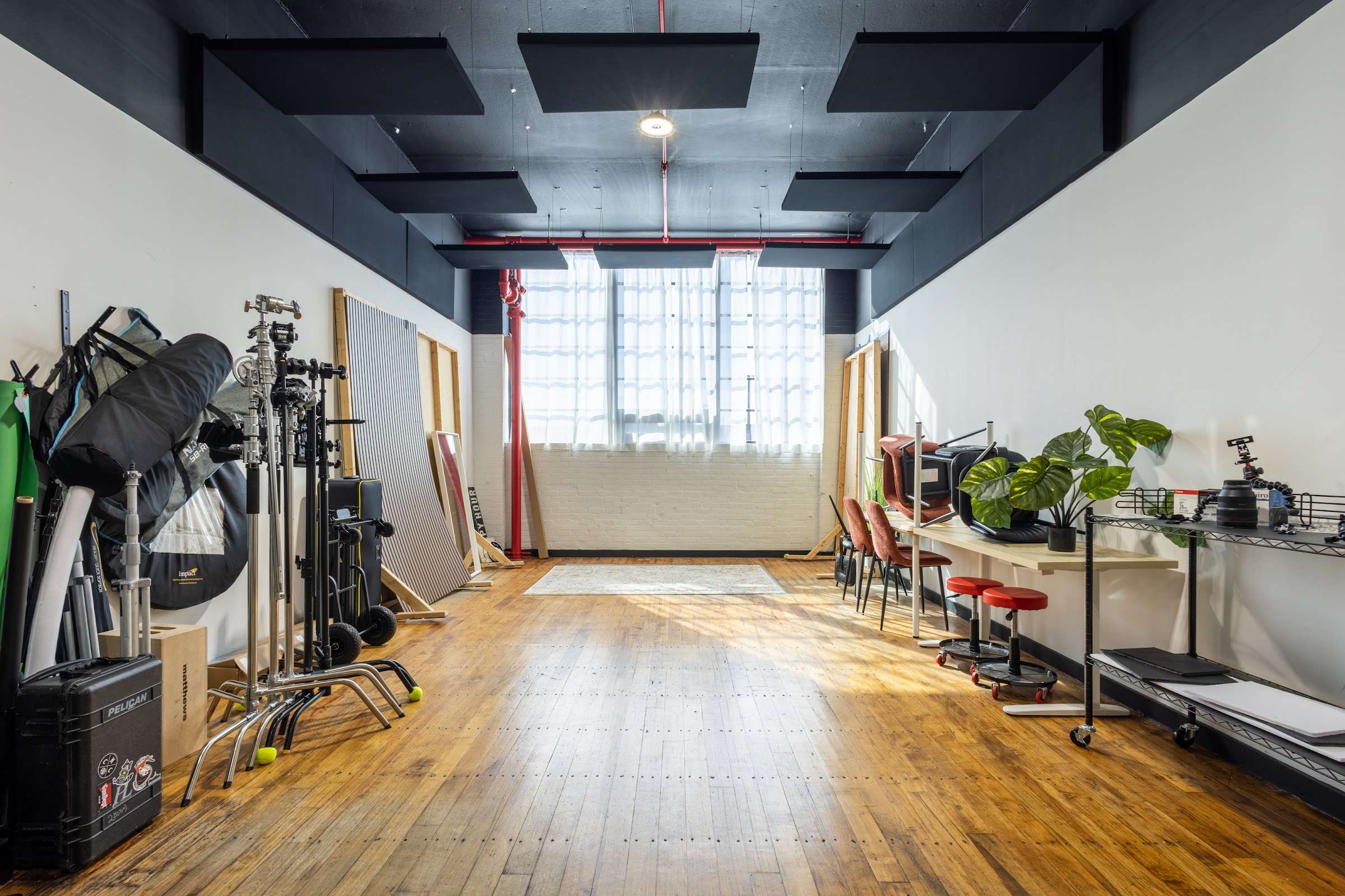 Studio 5 open floor facing the industrial windows with C-stands and backdrops